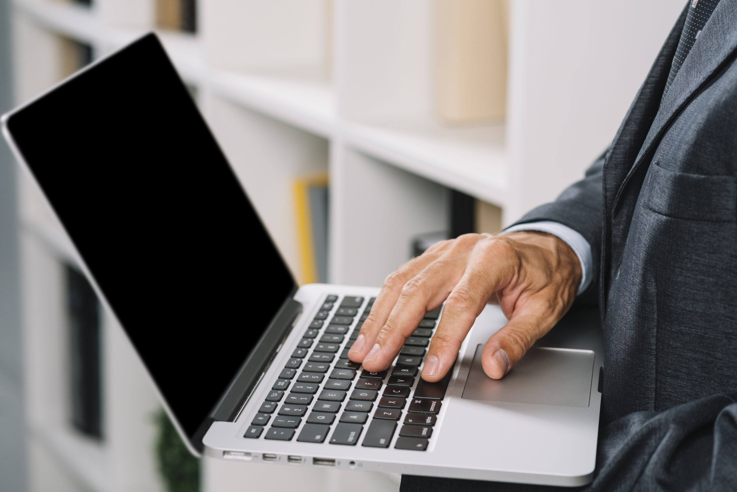 close-up-businessman-s-hand-tying-laptop